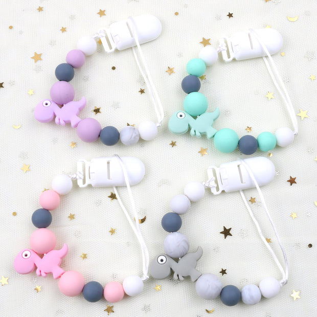 Multi-functional baby teether clip with engaging design, perfect for teething relief and hygiene.